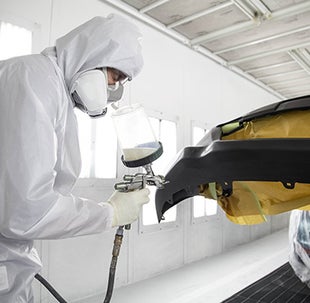 Collision Center Technician Painting a Vehicle | McCarthy Toyota of Sedalia in Sedalia MO